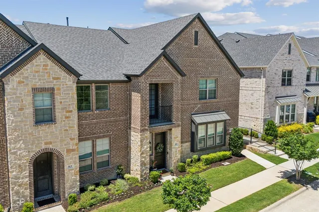 an aerial view of a house with a yard lake view and mountain view in back