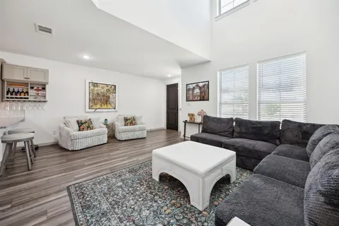 a spacious bedroom with a bed a couch and a window