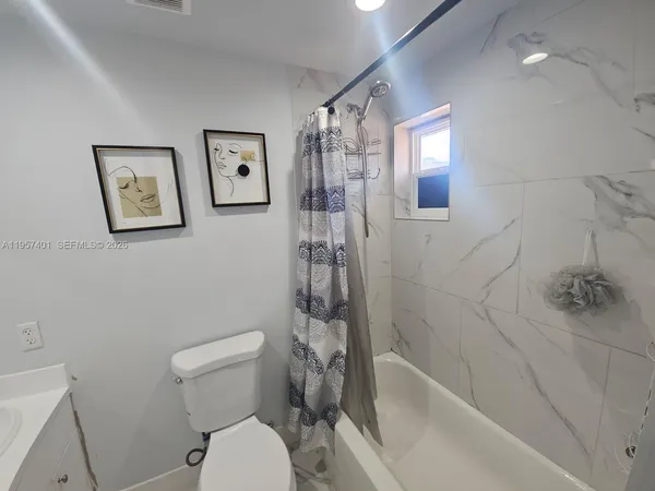 a bathroom with a toilet and a bathtub