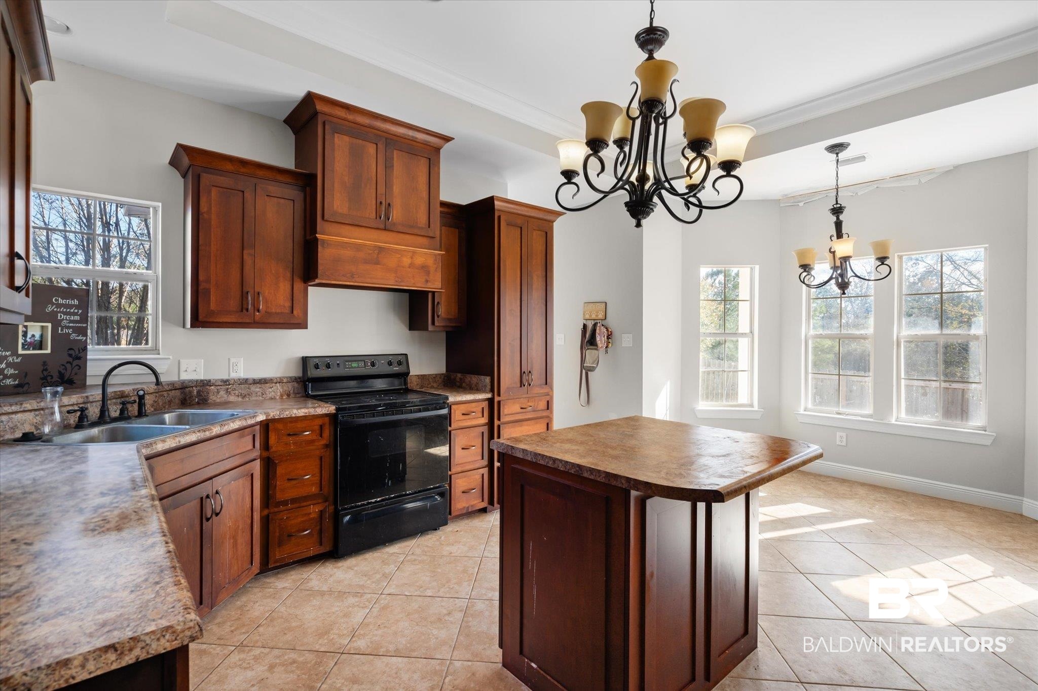 20792 Lonnie Walker Road Citronelle, AL 36522 - Photo 5 of 19 Kitchen featuring sink, a chandelier, hanging light fixtures, black range with electric cooktop, and a kitchen island