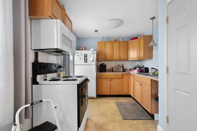 a kitchen with a stove top oven sink and cabinets