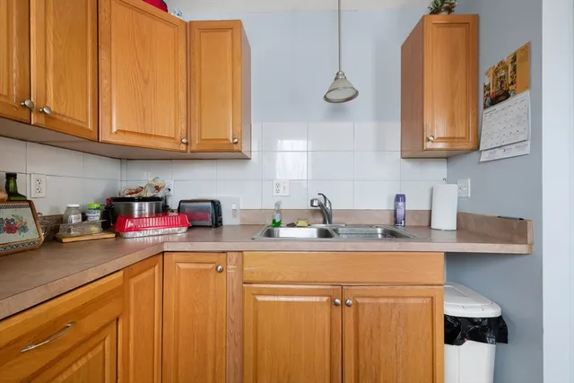 a kitchen with stainless steel appliances granite countertop a sink dishwasher stove and cabinets