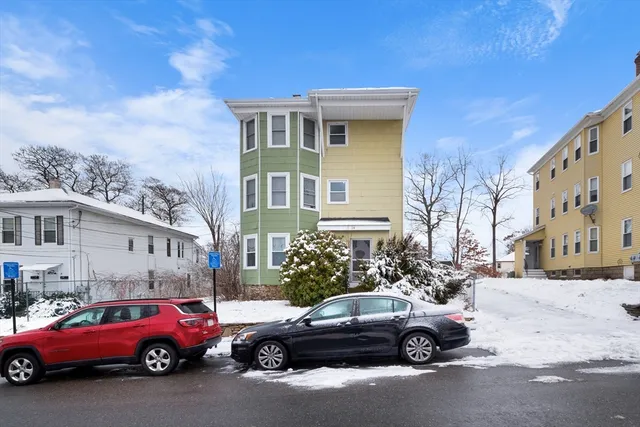 a view of a cars park in front of a building