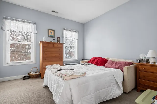 a bedroom with bed and window