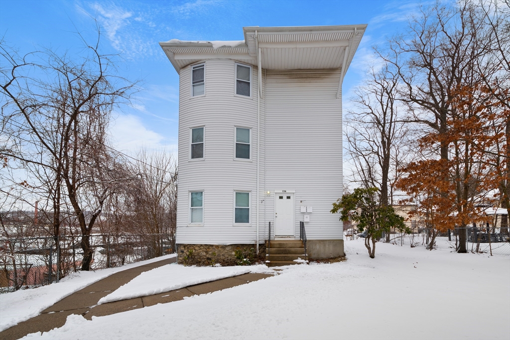 15 King Philip Road Worcester, MA 01606 - Photo 3 of 42 a front view of a house with a yard covered in snow