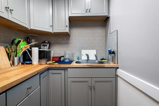 a kitchen with stainless steel appliances granite countertop a sink a stove and cabinets