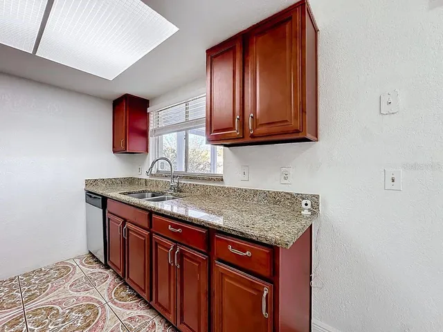 a kitchen with a sink and a window