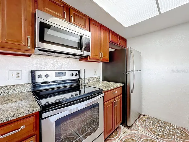 a stove top oven sitting inside of a kitchen