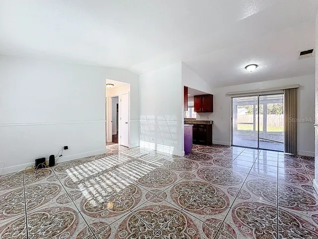 a view of a livingroom with wooden floor and a fireplace