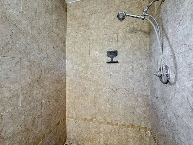 a bathroom with a shower a toilet and bathtub