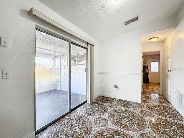 a view of an empty room with a sliding door
