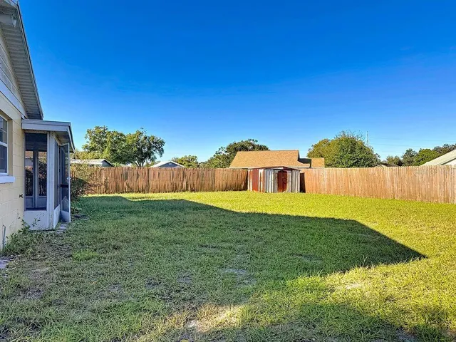 a aerial view of a house next to a yard