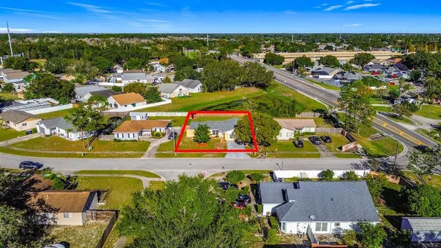 an aerial view of residential houses with outdoor space and swimming pool