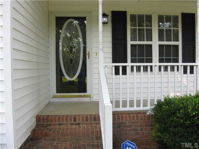 Cement wrap around porch. Steel door with glass. Very clean and neat.