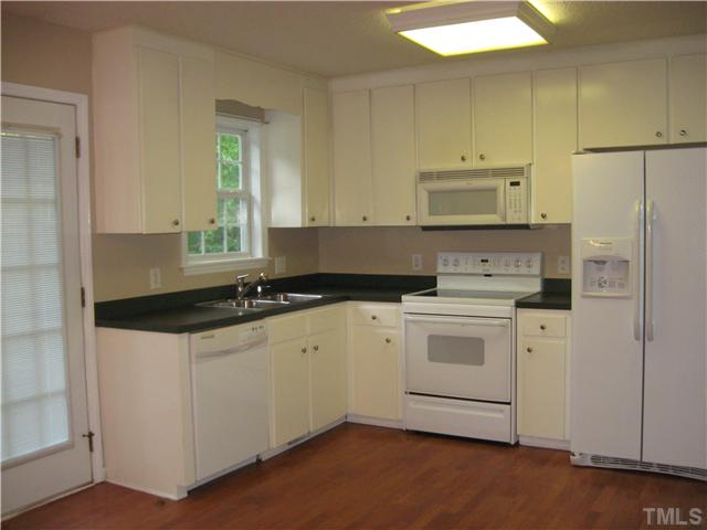 Large kitchen with dishwasher, smooth top stove, microwave and refrigerator. Custom cabinets and large walk in pantry.