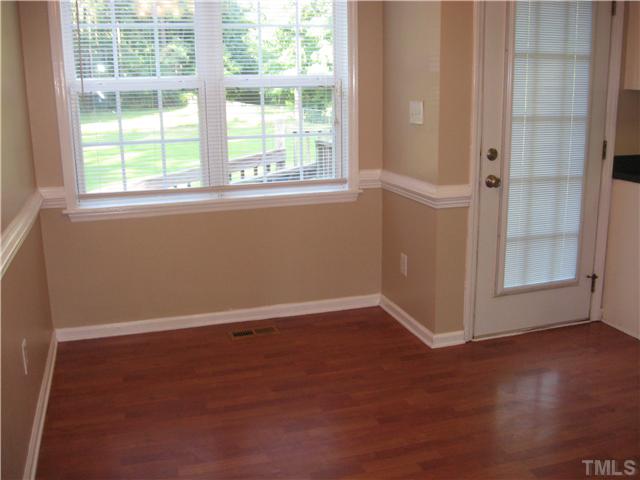 Large window in dining area overlooking the beautiful back yard. Back door has built in blinds.