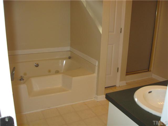 5519 Devils Racetrack Road Four Oaks, NC 27524 - Photo 8 of 12 Master bath has jetted tub, separate shower, double sinks and walk in closet. New floor covering has been ordered to match hall bath.