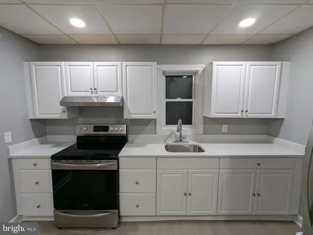 a kitchen with stainless steel appliances granite countertop a sink and a stove