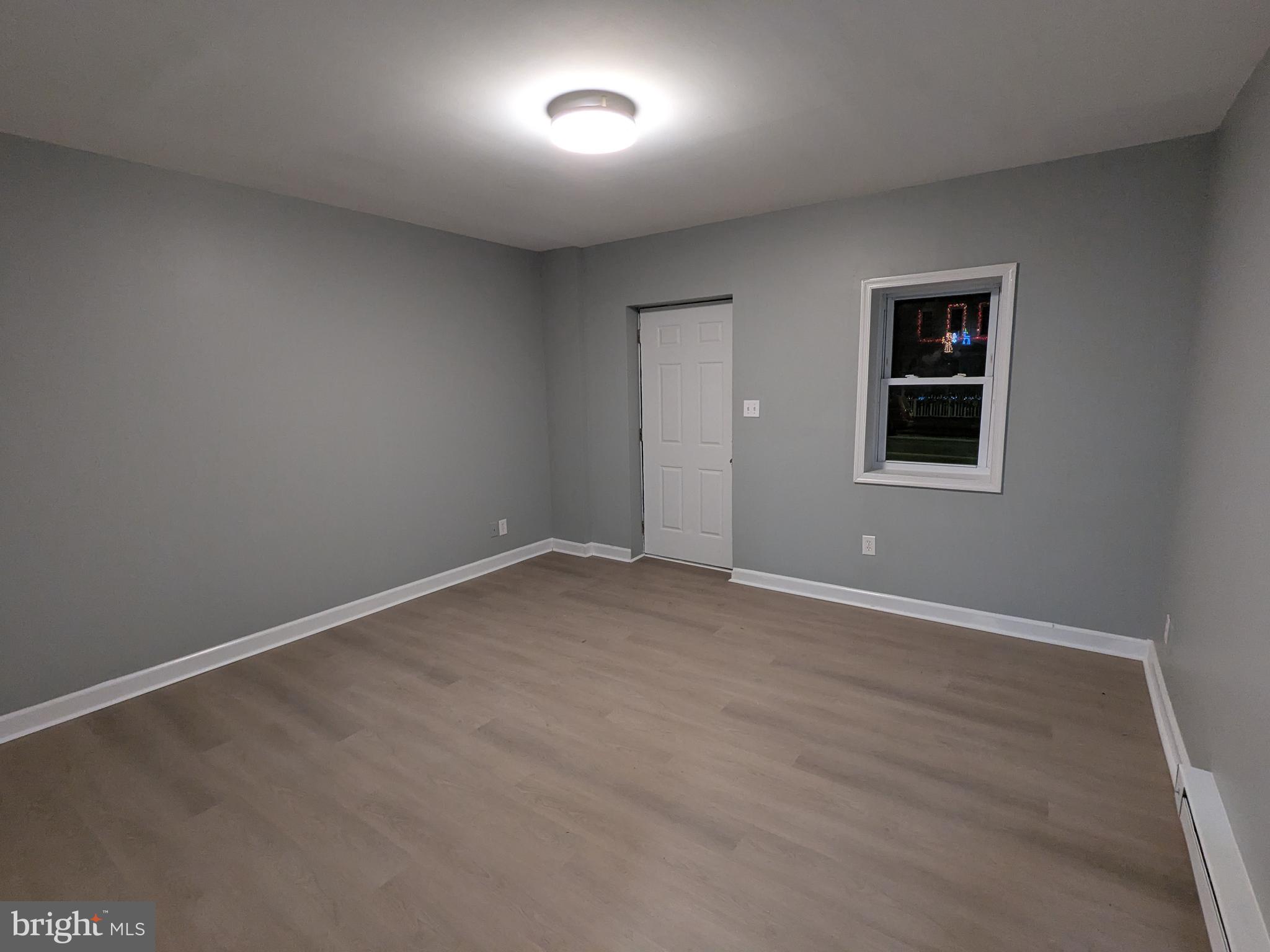 523 East Patapsco Avenue, Unit 1 Baltimore, MD 21225 - Photo 2 of 12 an empty room with windows