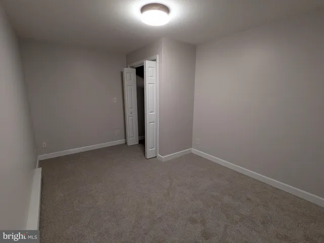 a white toilet sitting next to a bath tub