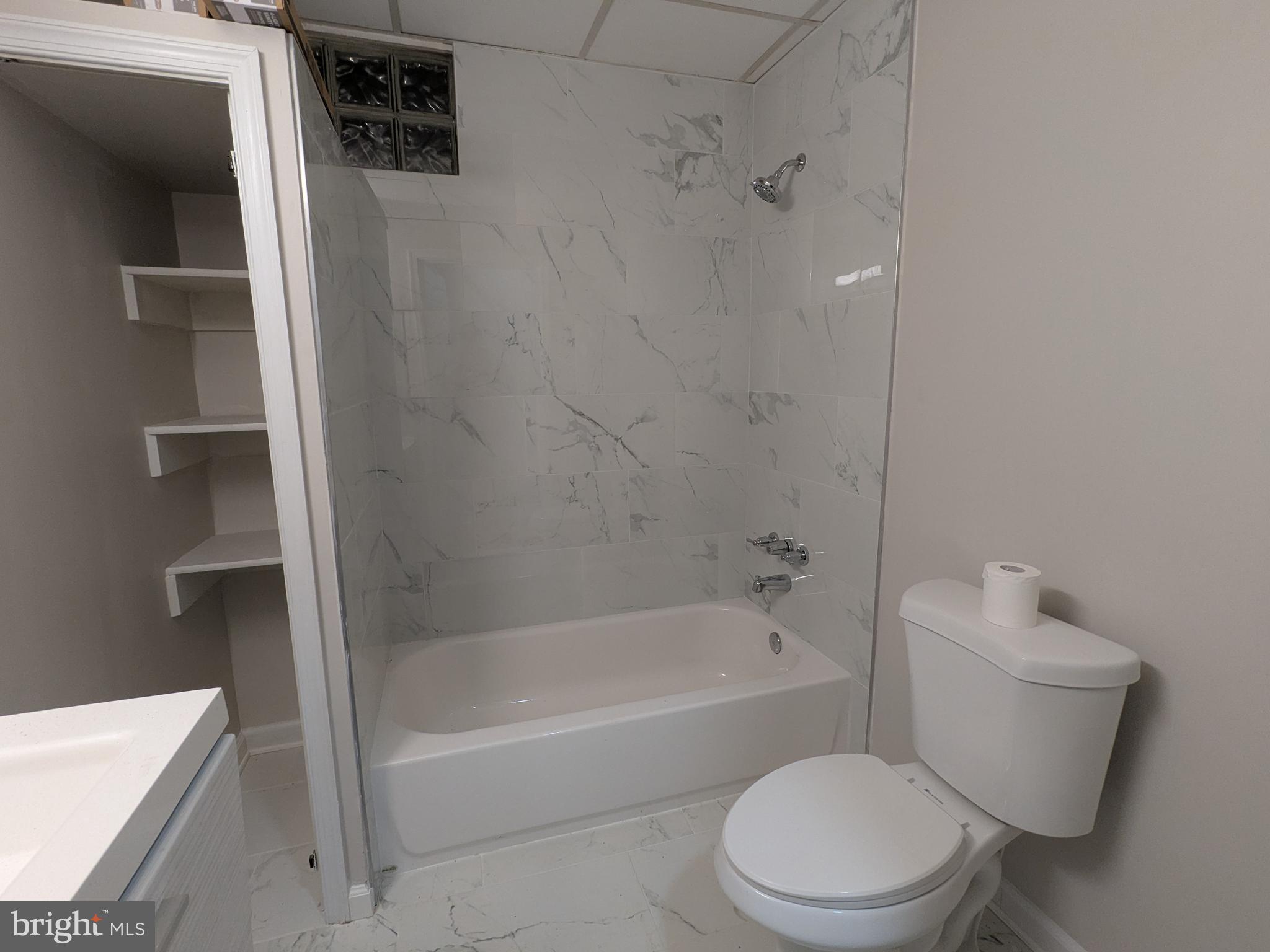 523 East Patapsco Avenue, Unit 1 Baltimore, MD 21225 - Photo 6 of 12 a white toilet sitting next to a bath tub