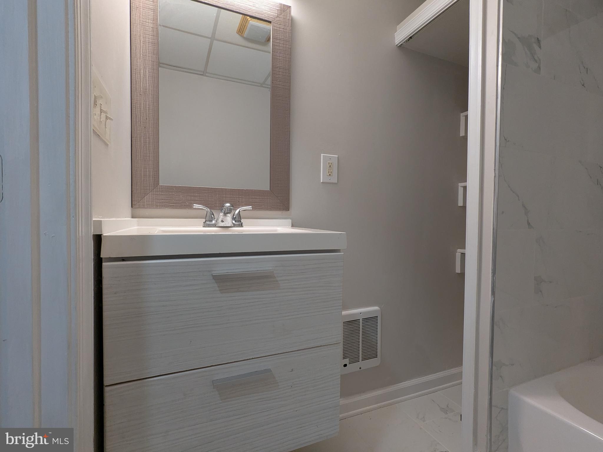 523 East Patapsco Avenue, Unit 1 Baltimore, MD 21225 - Photo 7 of 12 a bathroom with a sink and a vanity
