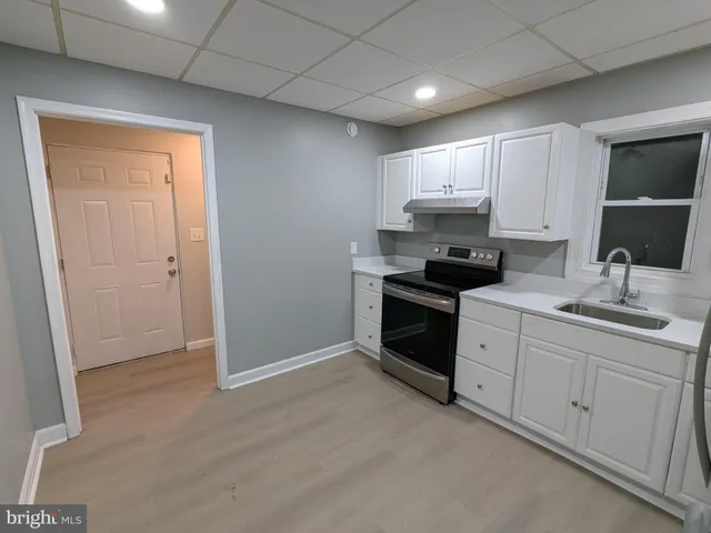 a kitchen with a refrigerator sink and cabinets