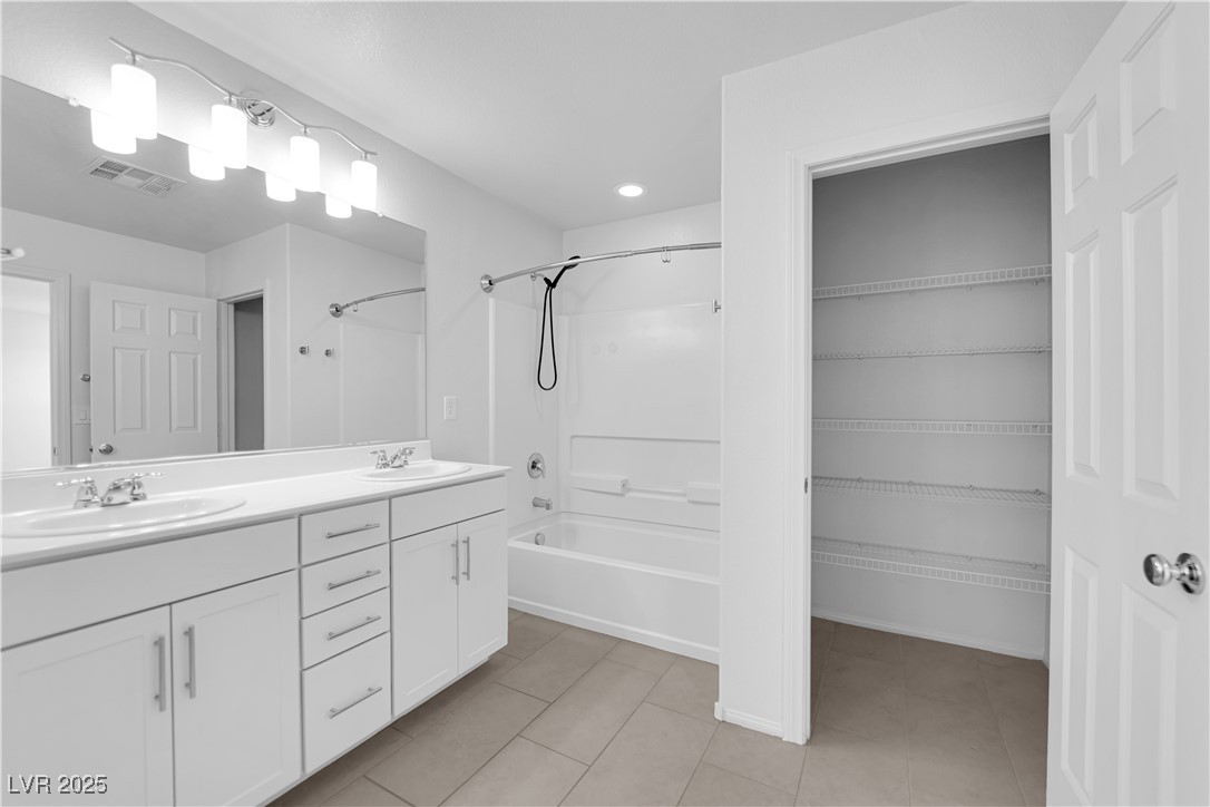 9205 Keystone Ridge Avenue Las Vegas, NV 89148 - Photo 34 of 40 Bathroom with shower combination, double vanity, tile patterned flooring, and recessed lighting