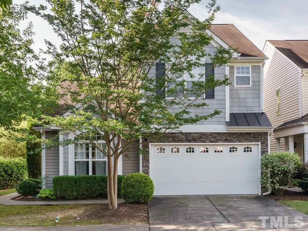 8411 Stonework Drive Raleigh, NC 27613 - Photo 1 of 19 a front view of a house with a garden