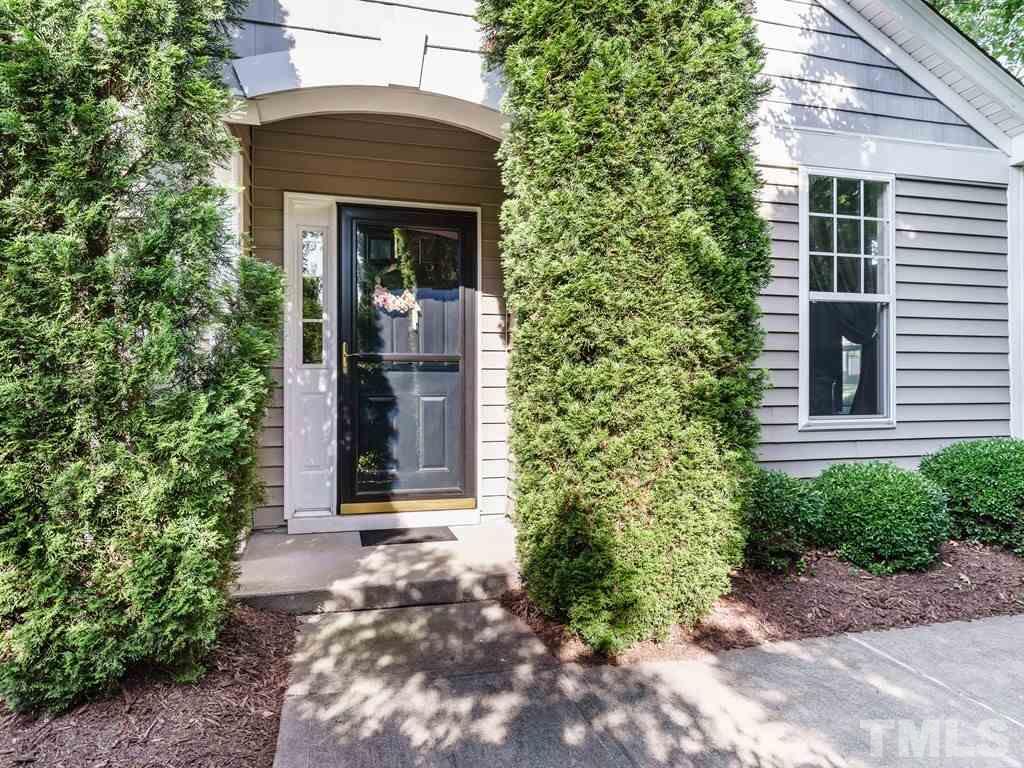 8411 Stonework Drive Raleigh, NC 27613 - Photo 2 of 19 a front view of a house with a garden