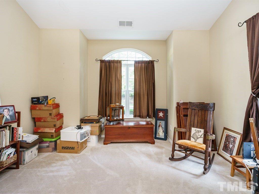 8411 Stonework Drive Raleigh, NC 27613 - Photo 11 of 19 a living room with furniture and a chandelier