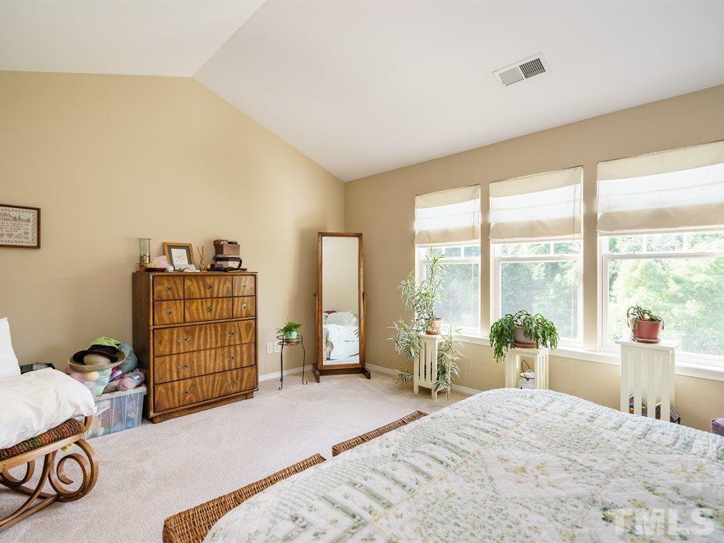 8411 Stonework Drive Raleigh, NC 27613 - Photo 13 of 19 a bedroom with a bed and large windows