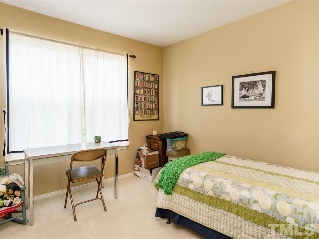 8411 Stonework Drive Raleigh, NC 27613 - Photo 15 of 19 a bedroom with a bed and a window