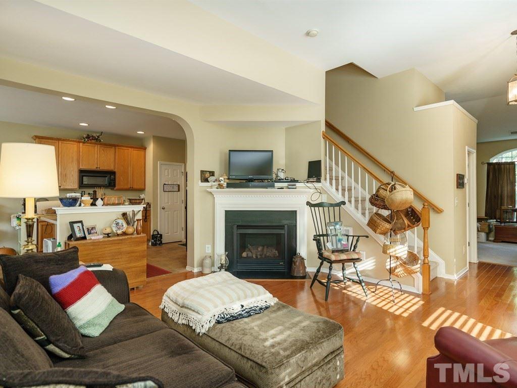 8411 Stonework Drive Raleigh, NC 27613 - Photo 6 of 19 a living room with furniture fireplace and flat screen tv