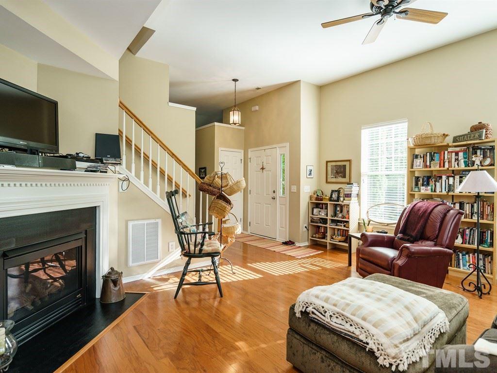8411 Stonework Drive Raleigh, NC 27613 - Photo 7 of 19 a living room with furniture fireplace and flat screen tv