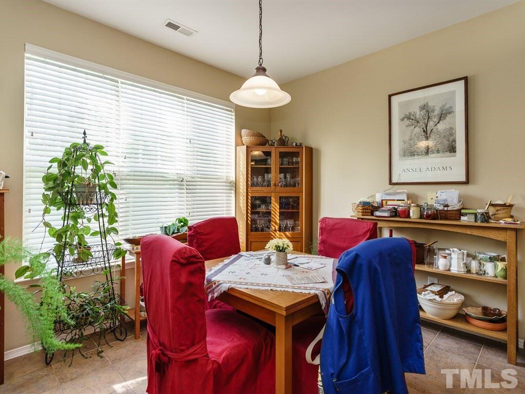 8411 Stonework Drive Raleigh, NC 27613 - Photo 8 of 19 a view of a dining room with furniture window and wooden floor