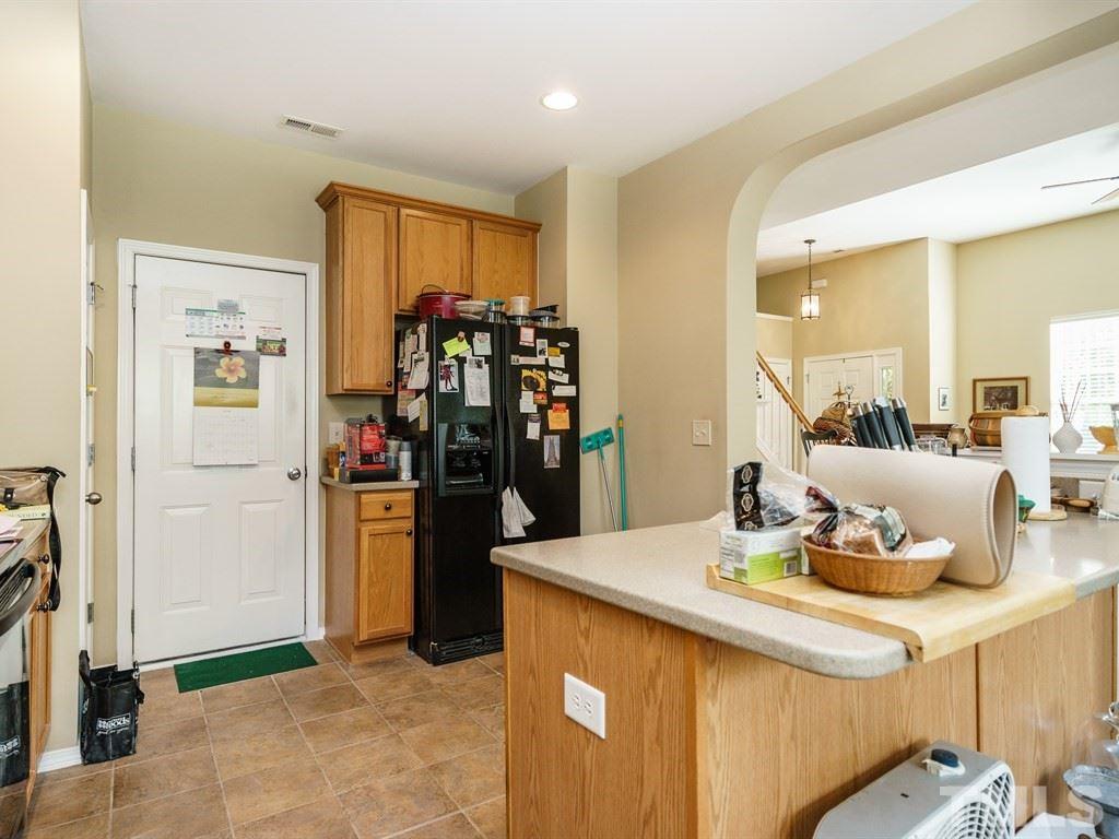 8411 Stonework Drive Raleigh, NC 27613 - Photo 9 of 19 a kitchen with a sink and refrigerator