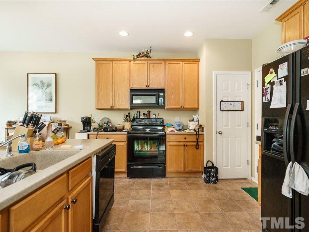 8411 Stonework Drive Raleigh, NC 27613 - Photo 10 of 19 a kitchen with stainless steel appliances granite countertop a refrigerator stove and sink