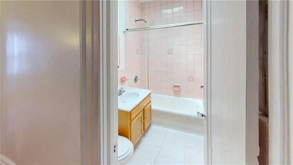2552 East 19th Street Brooklyn, NY 11235 - Photo 19 of 34 a bathroom with a granite countertop sink and a mirror
