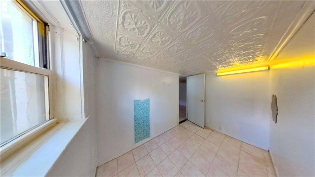 2552 East 19th Street Brooklyn, NY 11235 - Photo 22 of 34 a view of a big room with wooden floor and windows