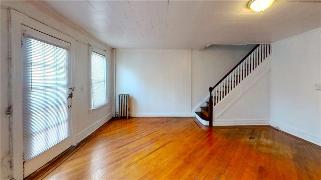 2552 East 19th Street Brooklyn, NY 11235 - Photo 4 of 34 a view of an empty room with wooden floor and a window