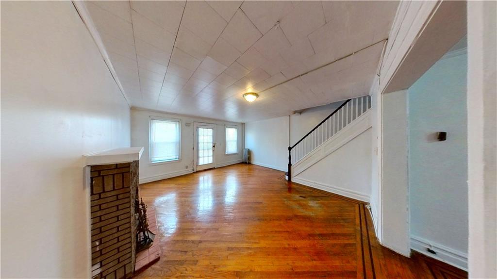 2552 East 19th Street Brooklyn, NY 11235 - Photo 5 of 34 a view of empty room with wooden floor