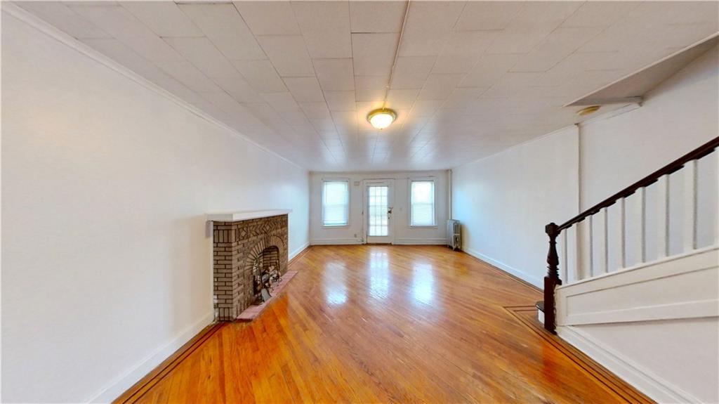 2552 East 19th Street Brooklyn, NY 11235 - Photo 6 of 34 a view of an empty room with window and wooden floor