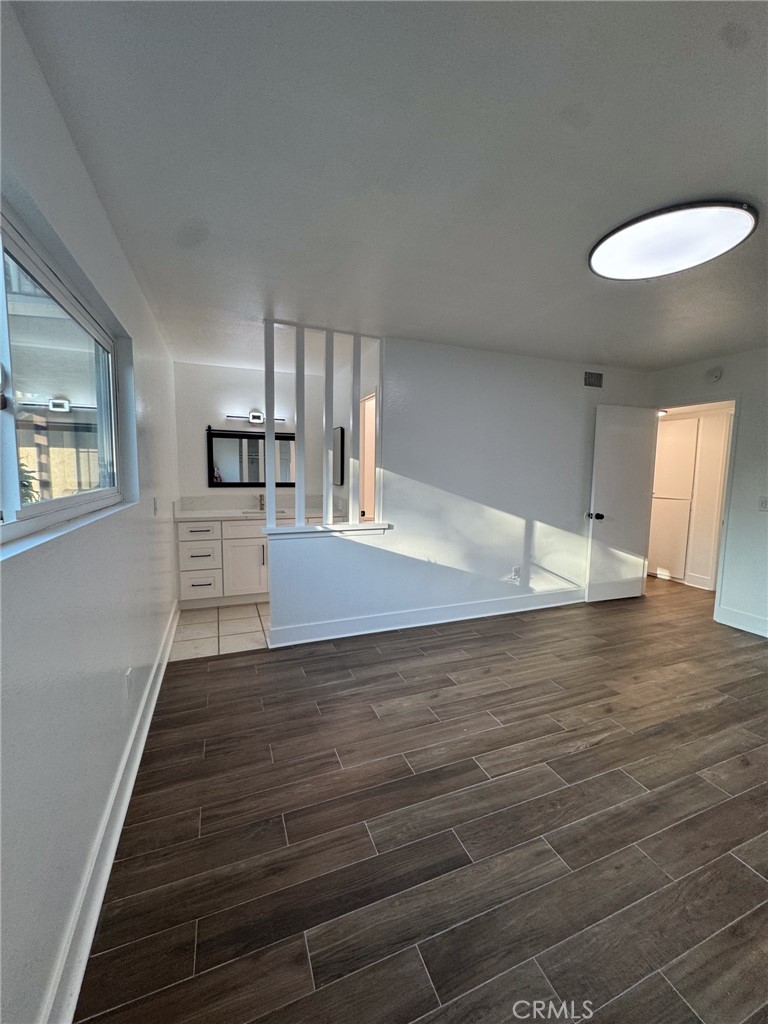 1215 South Athena Way Anaheim, CA 92806 - Photo 11 of 16 a view of empty room with wooden floor and window