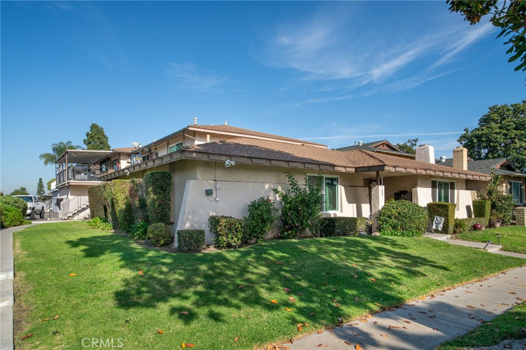 1215 South Athena Way Anaheim, CA 92806 - Photo 3 of 16 a front view of a house with garden