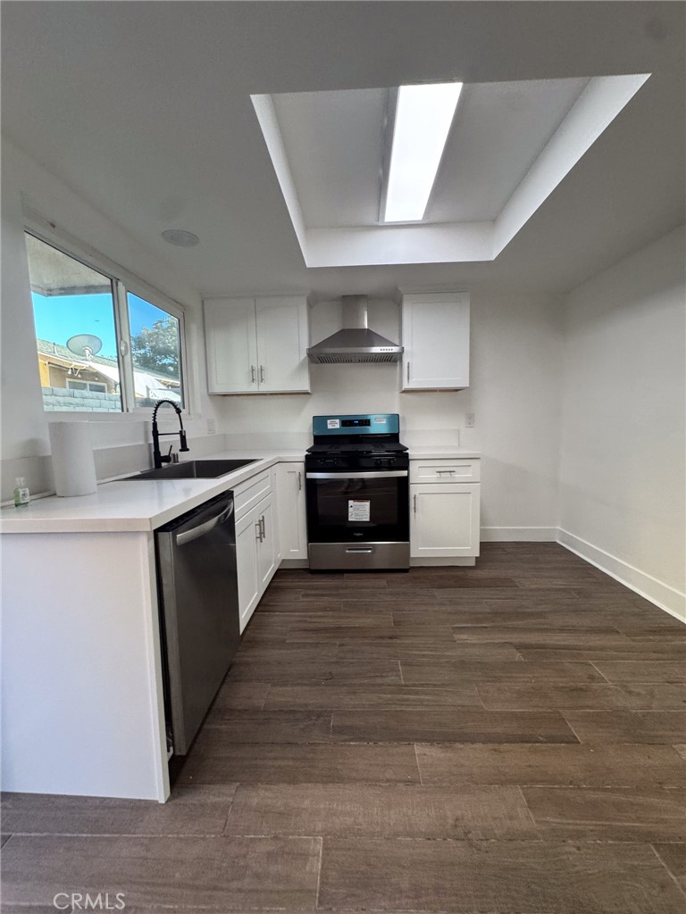 1215 South Athena Way Anaheim, CA 92806 - Photo 8 of 16 a kitchen with granite countertop a sink and a stove top oven