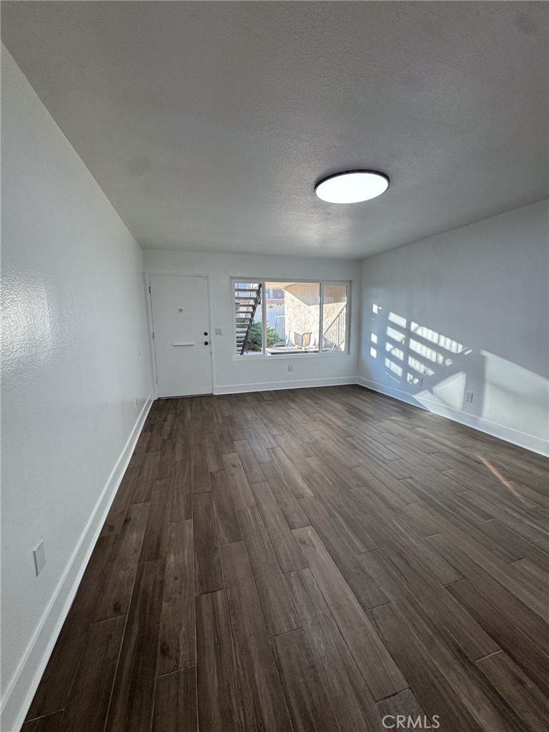 1215 South Athena Way Anaheim, CA 92806 - Photo 9 of 16 wooden floor in an empty room with a window