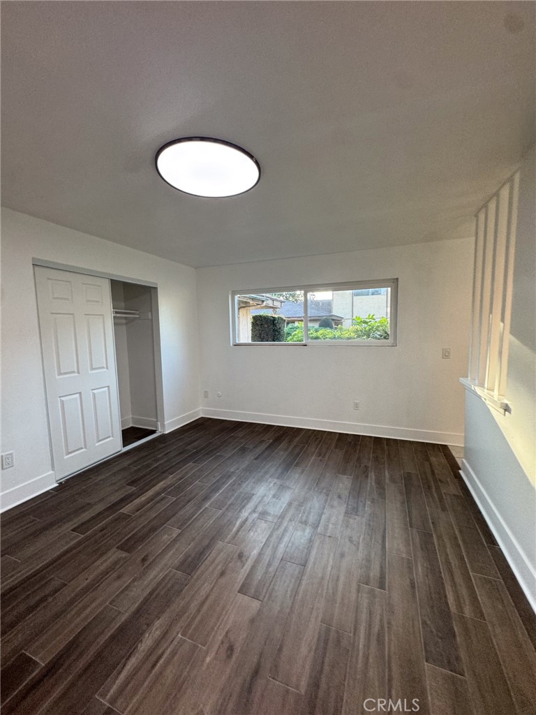 1215 South Athena Way Anaheim, CA 92806 - Photo 10 of 16 an empty room with wooden floor and windows