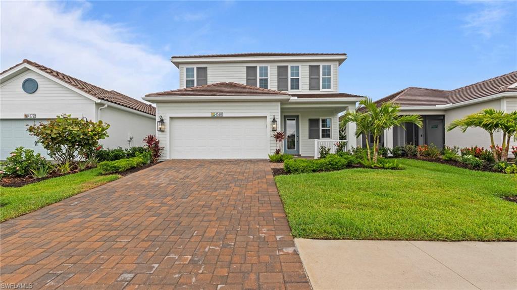 4568 Centaurus Circle Naples, FL 34120 - Photo 2 of 47 a front view of a house with a yard