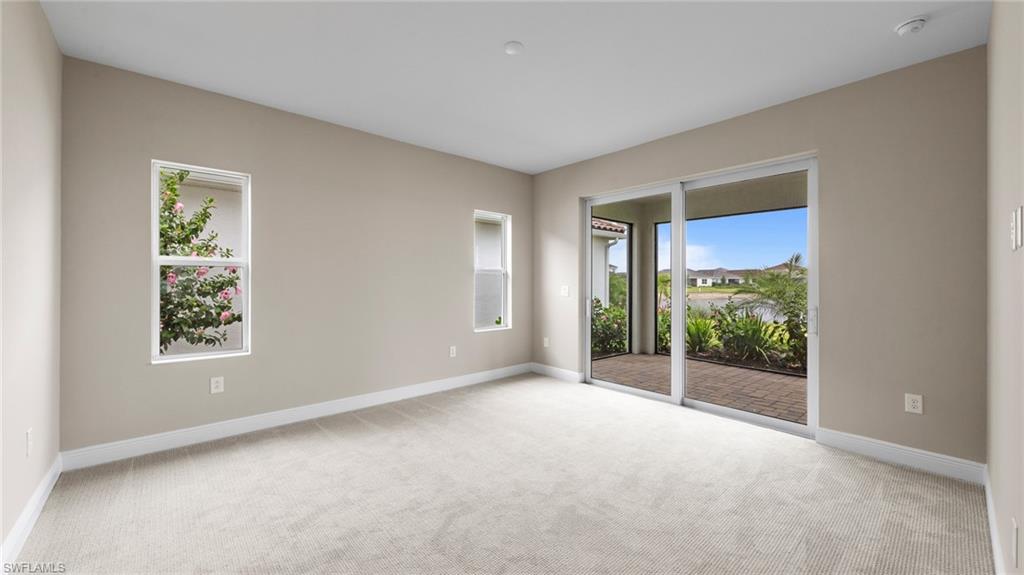 4568 Centaurus Circle Naples, FL 34120 - Photo 21 of 47 an empty room with windows